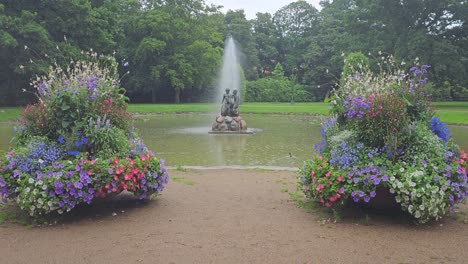 pond with fountain in an urban park in aalborg, denmark