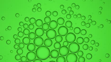 group of small bubbles on a green screen 4k macro