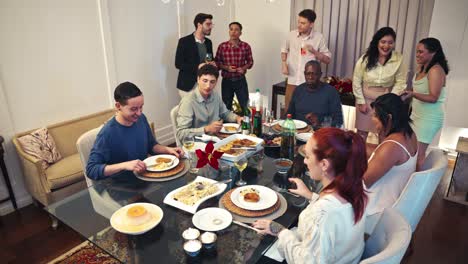 a group of people enjoying a meal together at a dining table