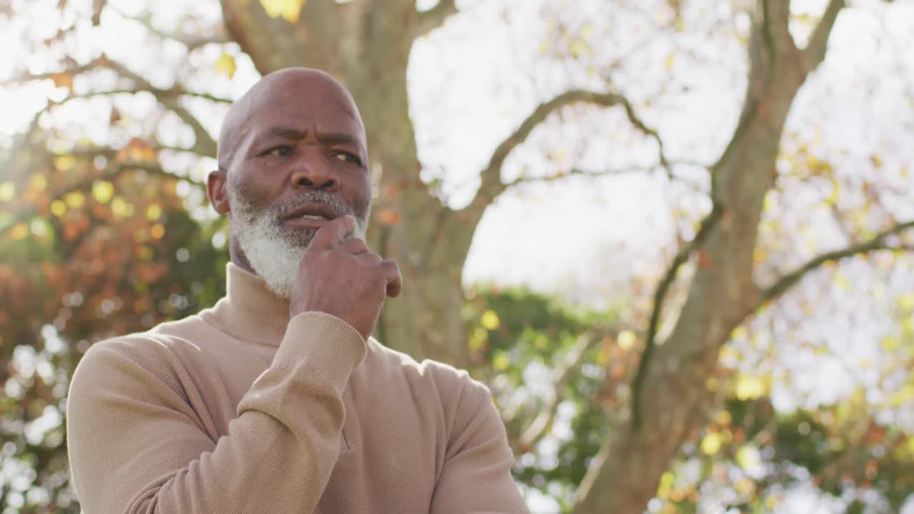 Video of thoughtful senior african american man contemplating in garden