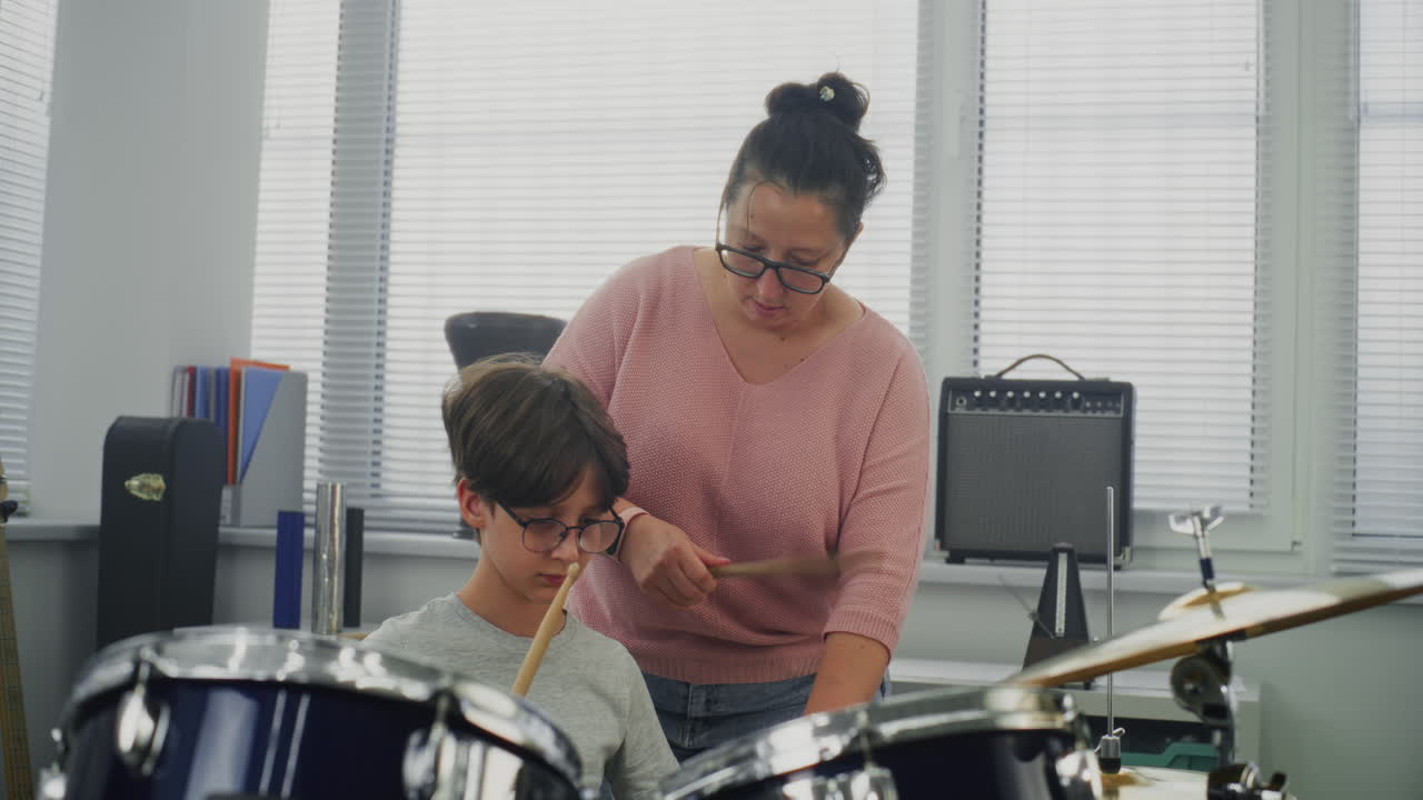 Primary School Boy Practicing Sense of Rhythm Playing Drums in Music Class