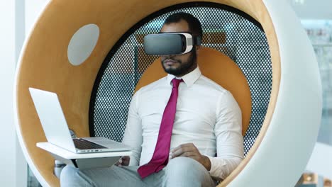 man using vr headset and laptop