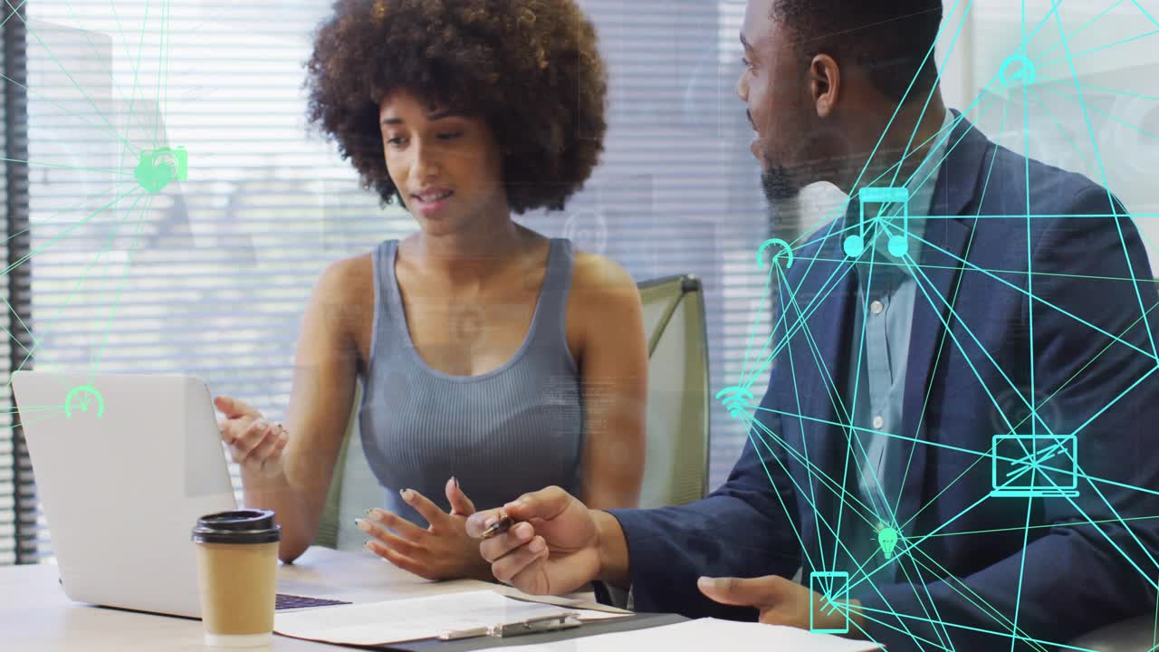 Woman pointing at laptop, reviewing biz docs while man leaning in, teal overlay showing laptop data
