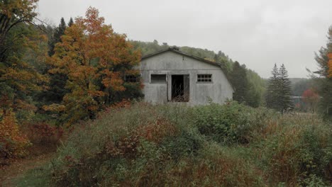 Rustic-old-abandoned-barn-surrounded-by-trees-and-bush-in-Montpellier-Quebec
