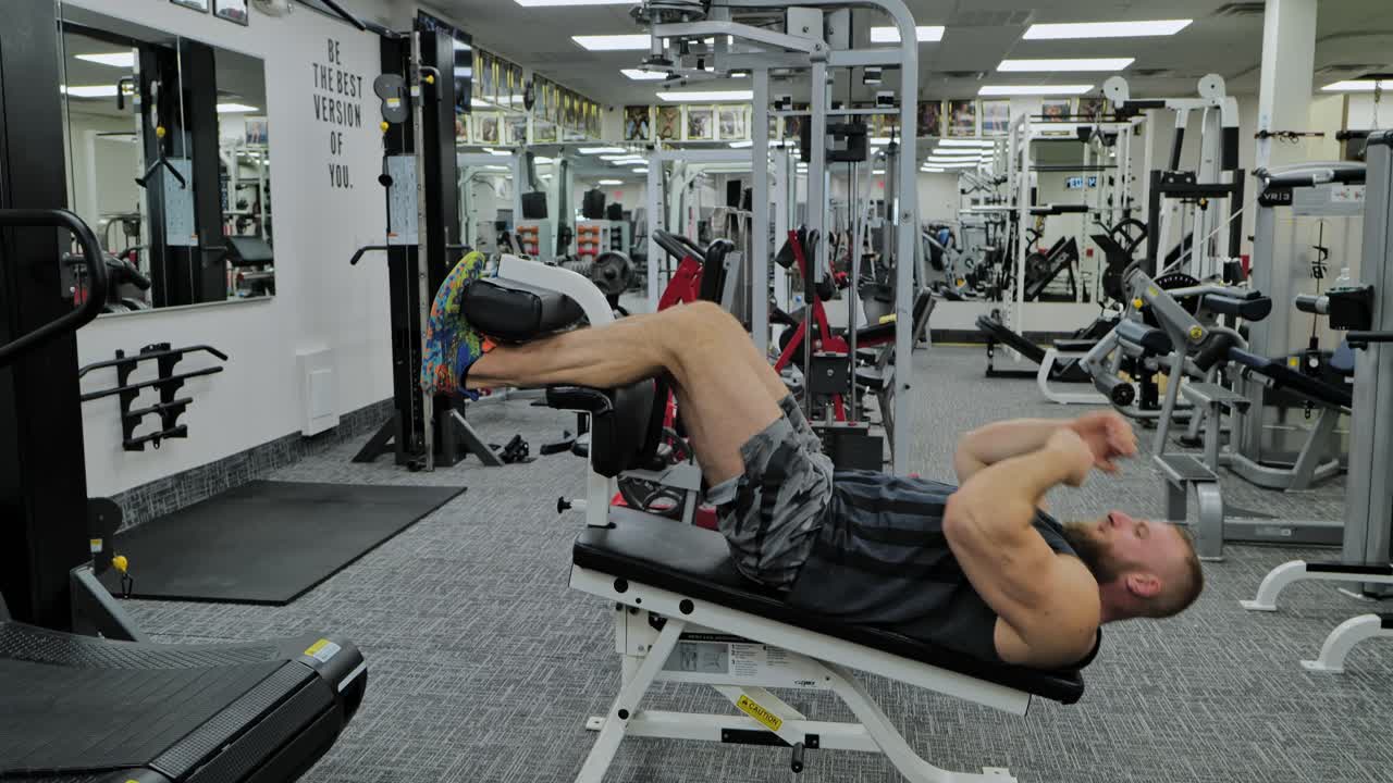 Active bodybuilder young man lifting heavy weights