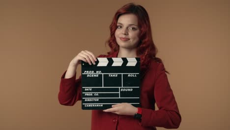 woman holding clapperboard