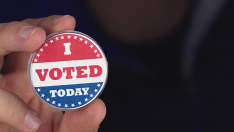 4k resolution closeup video of a hand holding i voted today button. elections concept