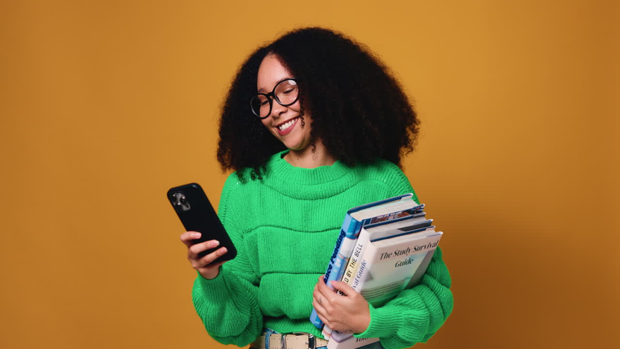Woman with Afro Holding Books and Smartphone