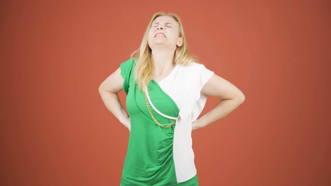 카메라를 바라보는 여자가 가려움증을 느끼고 있습니다.