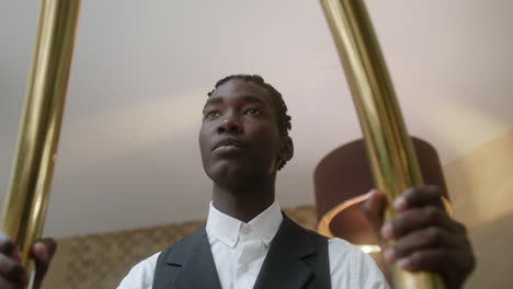 bellhop carrying a hotel luggage cart