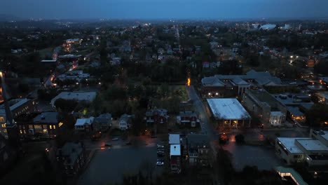 aerial flight over housing area and neighborhood of american town at night. rainy day in autumn season. lighting streets and houses with clouds at sky. wide shot. lynchburg, virginia, usa.