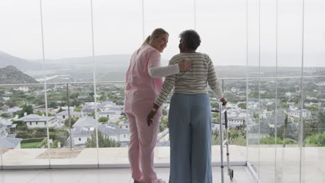 Smiling-caucasian-nurse-with-senior-woman-patient-with-copy-space,-slow-motion