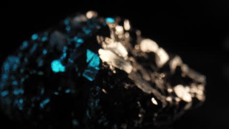 Slow-dolly-in-rack-focus-to-mesmerizing-studio-lit-pyrite-against-a-black-background