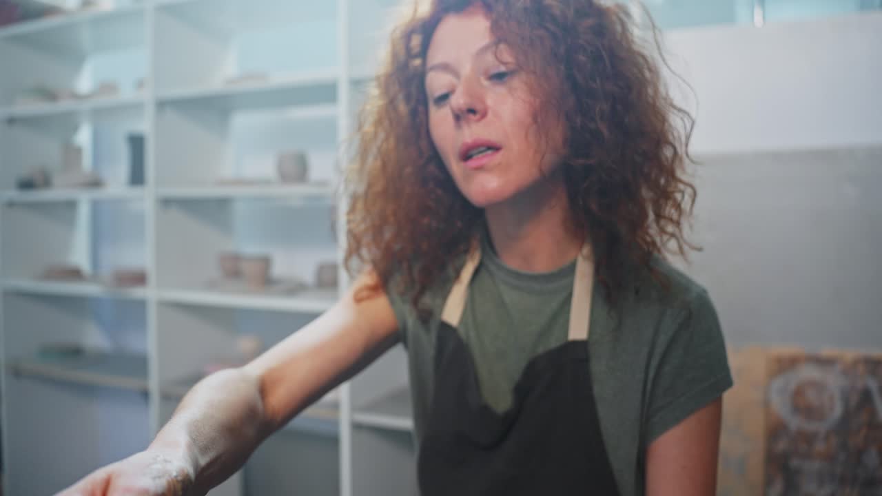 Woman Working on Pottery in a Studio