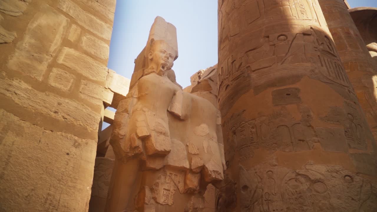 The statue of King Ramses in the Karnak Temple, Luxor Egypt. 
Slow camera slide from a low angle.