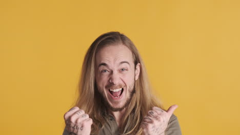 caucasian young man celebrating victory in front of the camera.