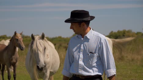 cowboy leading the horses back to the ranch