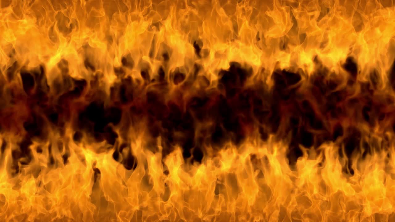 Fire flames on black background. Burning fire flame. Abstract background on the theme of fire, light and life. Fiery orange glowing. Strong fire. Big burning bonfire. Burning fields. Loop 4K
