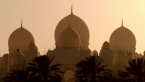 the domes of the beautiful sheikh zayed mosque in abu dhabi united arab emirates at sunset 1