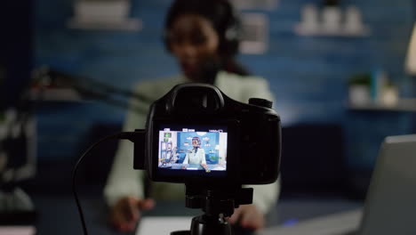 African-influencer-recording-blog-looking-at-professional-camera