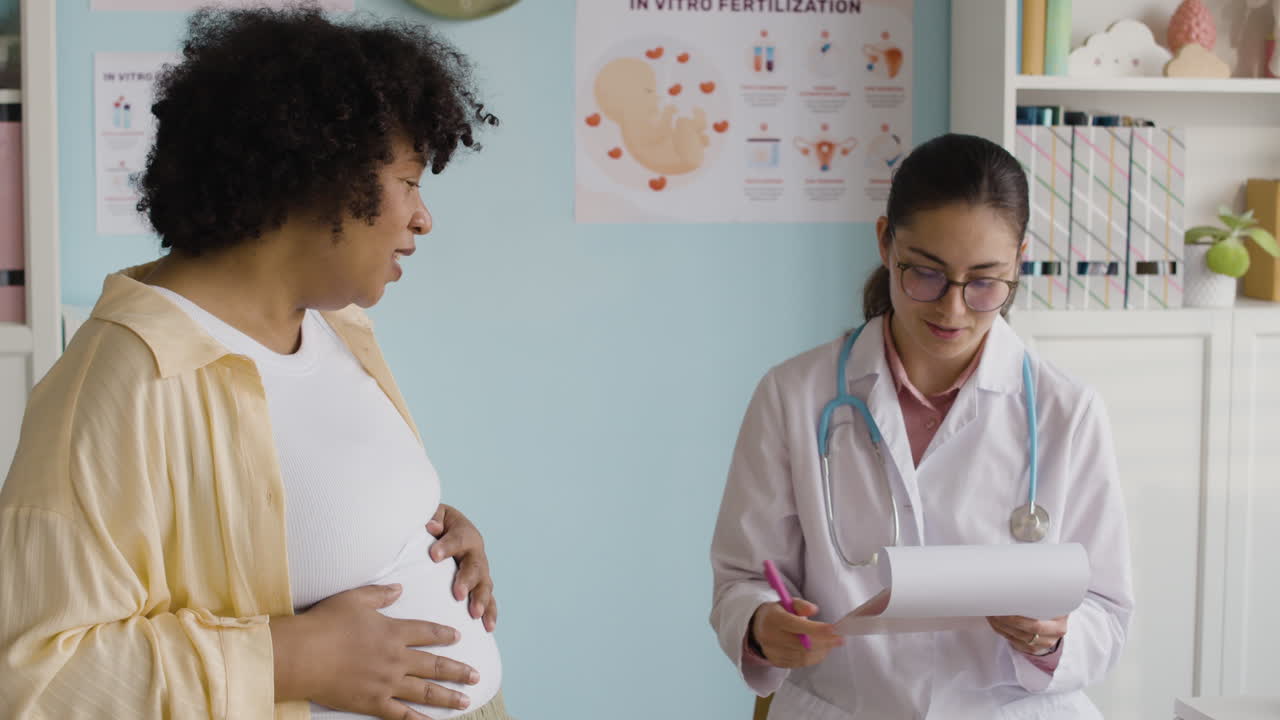 Pregnant woman consulting with her doctor