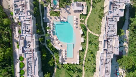 Aerial-top-down-shot-of-luxury-The-Westin-Puntacana-Resort-Club-with-private-sandy-beach-to-the-Caribbean-sea-in-sunlight---establishing-shot