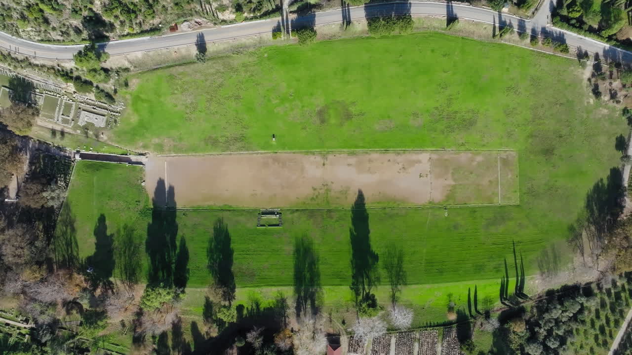 Overhead aerial shot of ancient Olympia stadium and archaeological site, Elis region, Peloponnese