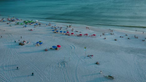 Aerial-Drone-Fly-Above-Praia-Grande-Arraial-Do-Cabo-Panoramic-Beach-Shore-Brazil-People-on-Holidays-Relaxing-in-Summer-Sunset,-Cinematic-Blue-Skyline