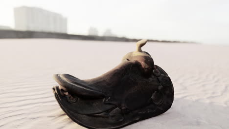 old horse saddle on the beach