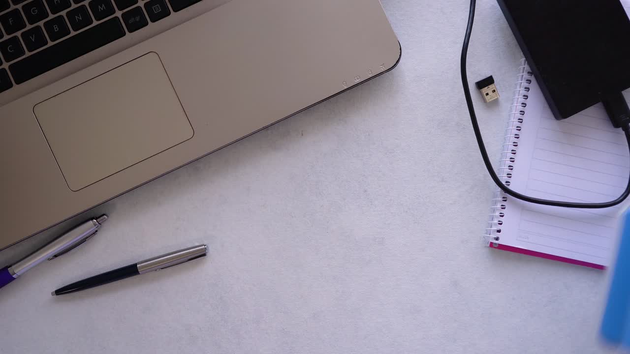 Top view of a person arranging his desk in the office