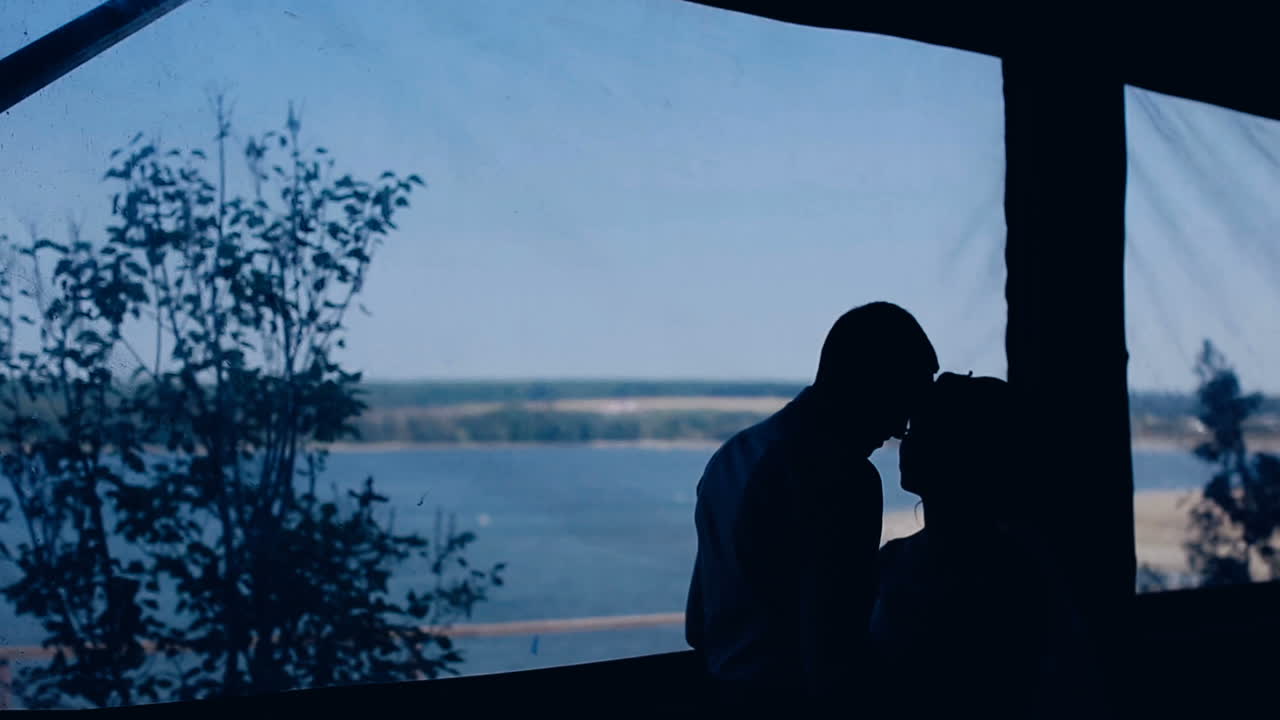 Lovely wedding couple. Silhouette of romantic and happiness couples near lake