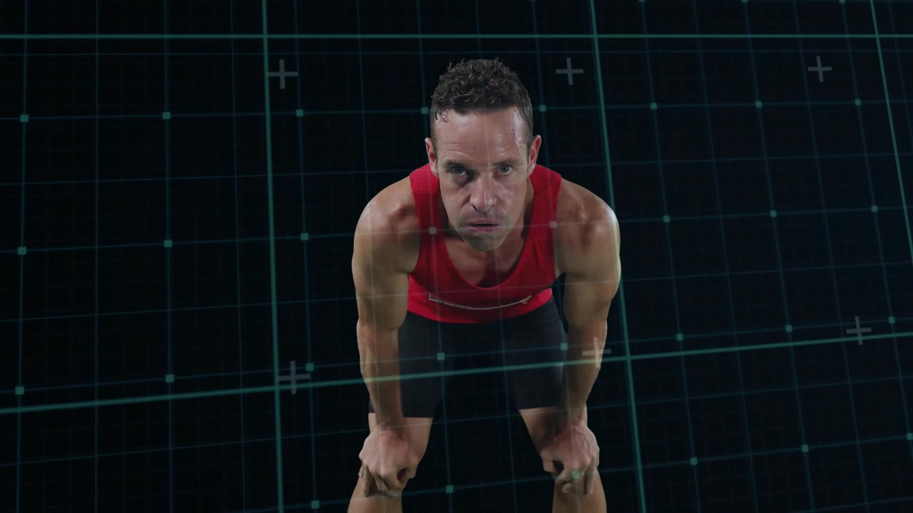 Atleta masculino inclinándose hacia adelante después de un sprint, respirando, recuperándose con un HUD de fitness que rastrea el movimiento.