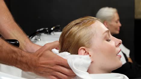 hair stylist drying man hair with towel