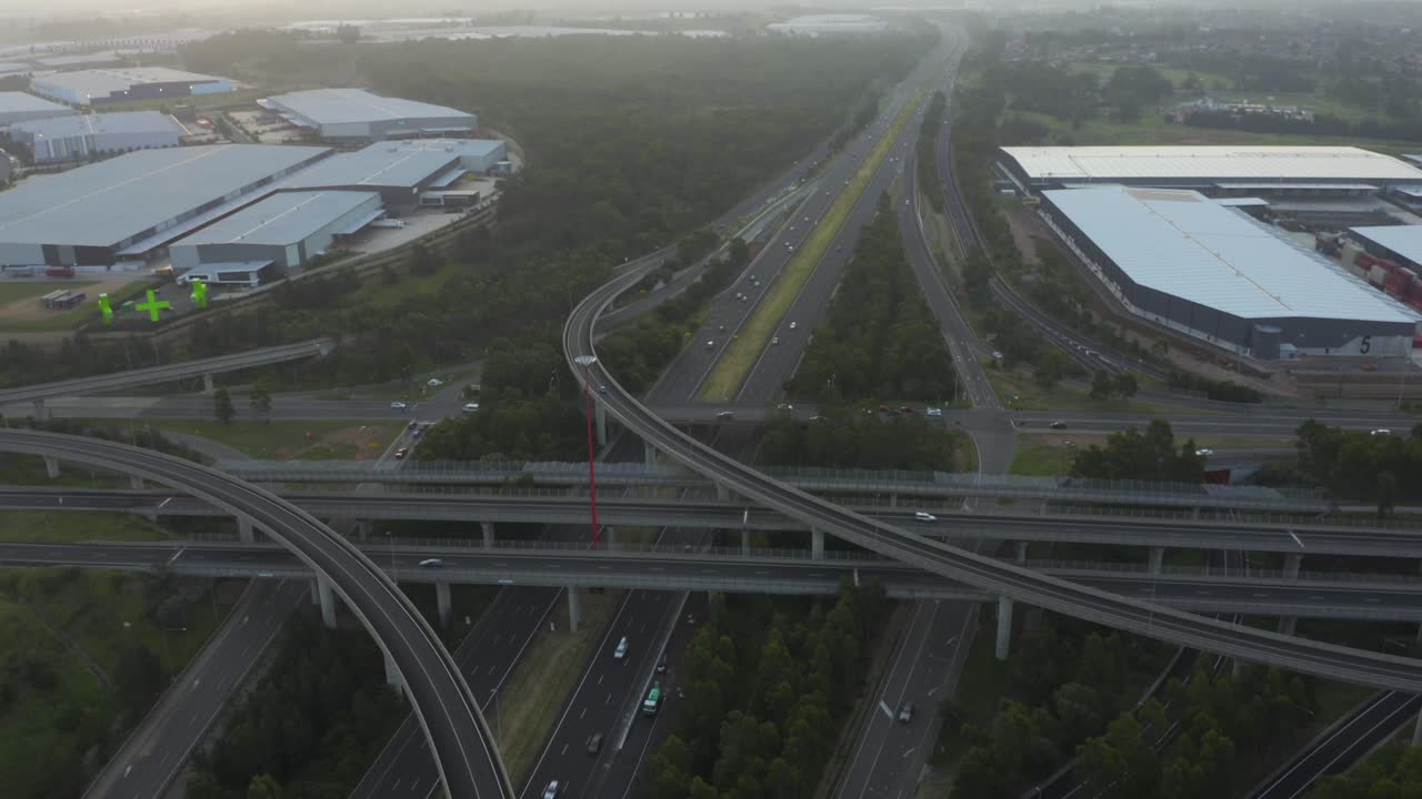 Motorways M4 and M7 light horse interchange in Sydney western suburbs &ndash; aerial panning over multi-lane highways with traffic