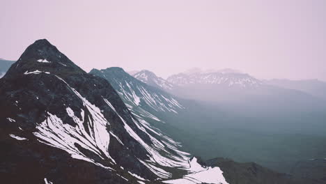 majestic mountain range under a soft mist during dawn in a serene landscape
