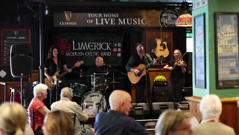 musicians playing in a pub with an attentive audience