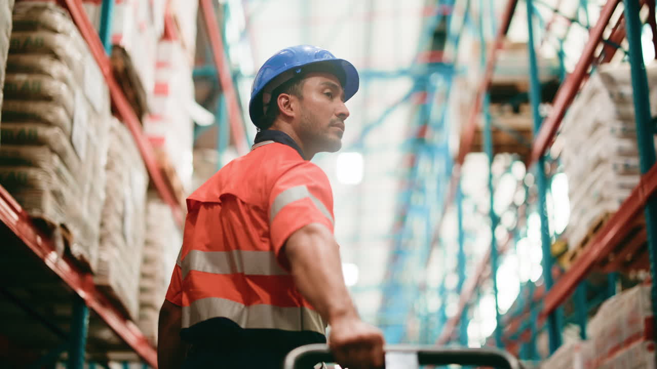 Warehouse Worker Inspecting Stock in a Large Industrial Storage Facility