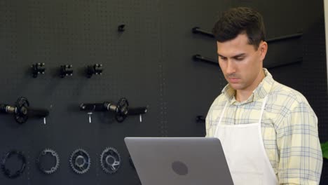 man using laptop in workshop 4k