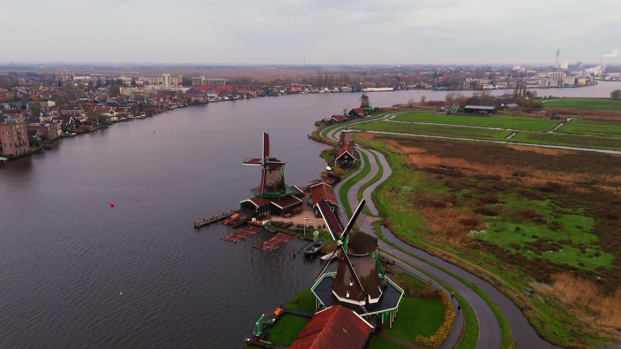 Dronevideo of the Windmills of zaanse schans (close to Amsterdam) in the early dawn lights.