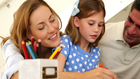 Happy-parents-and-daughter-colouring-together