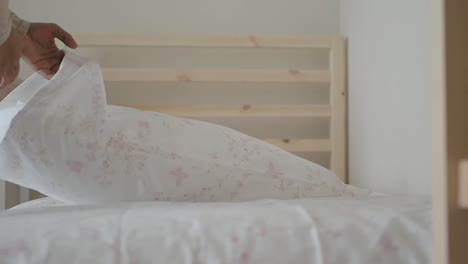 person making bed