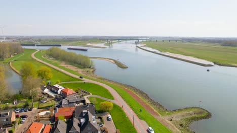 Aerial-view-approaching-boat-on-river-in-Dutch-countryside