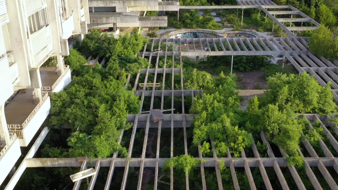 Reverse flyover above overgrown courtyard of abandoned Haludovo Palace Hotel