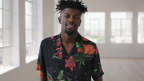 slow-motion-portrait-of-relaxed-african-american-man-laughing-happy-looking-at-camera-enjoying-lifestyle-change-wearing-hawaiian-shirt-in-new-apartment