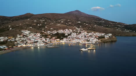 Dusk-aerial-view-of-Batsi,-a-traditional-village-at-the-island-of-Andros,-Cyclades,-Greece