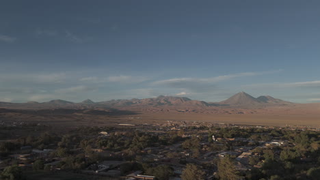 upwards flying drone shot above san pedro de atacama chile south america on a blue but cloudy day with mountains in the background log