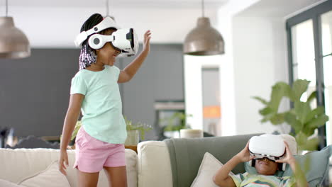 african american sister and brother are engaged in virtual reality gaming at home