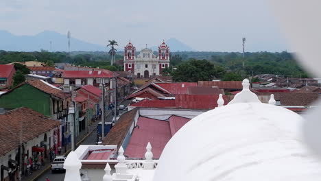 the old el calvario church in leon nicaragua with distant volcano cone