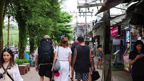 backpackers walking through vibrant market street