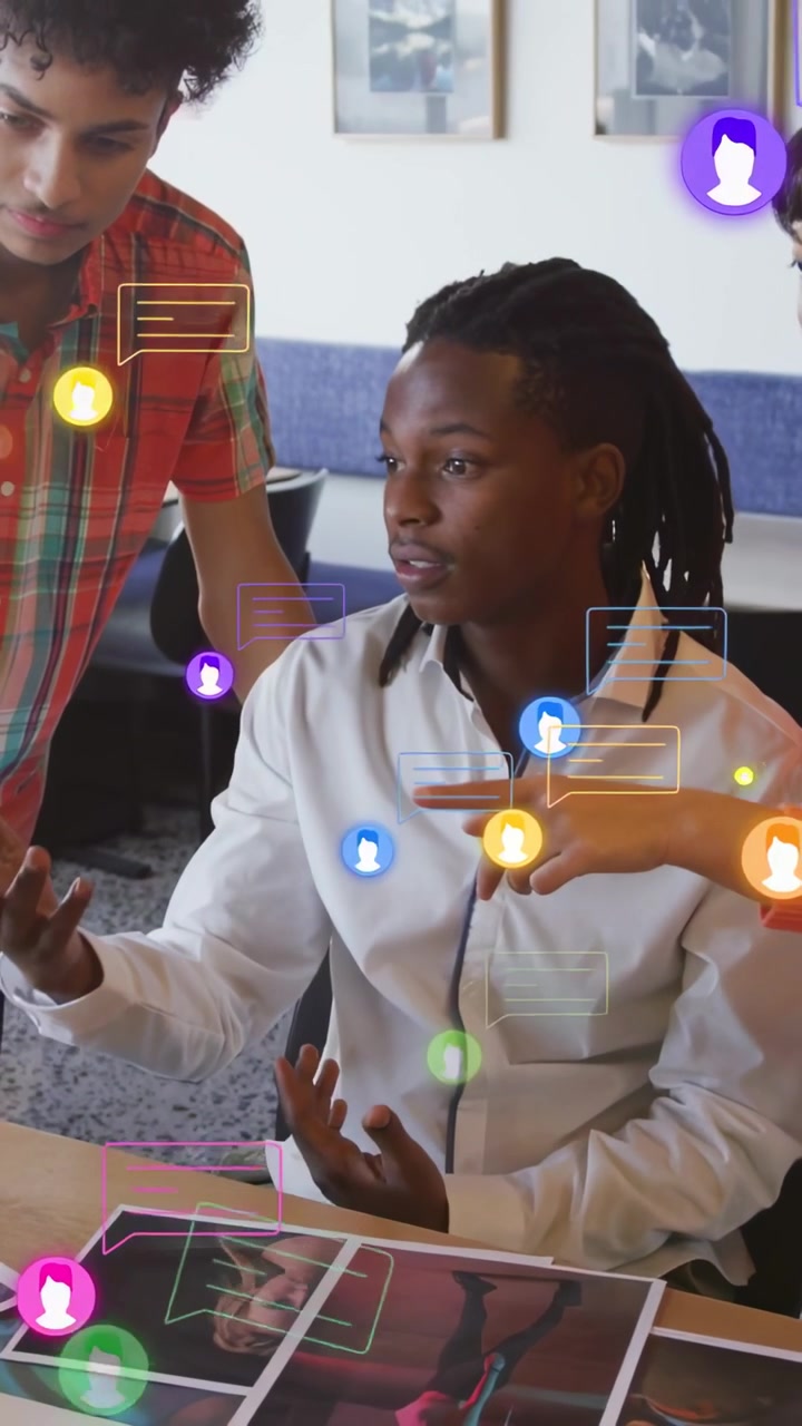 Vertical video: Braided man white top viewing prints at office, chat icons appearing, picking pics